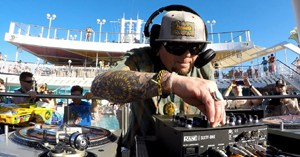 DJ Trichrome spinning tracks on a concert cruise ship opening for 311