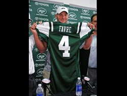 Brett Favre holding up the Jets jersey